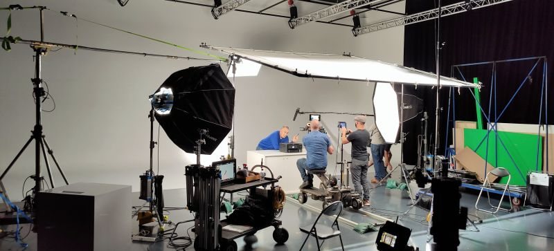 Television production crew filming in a studio